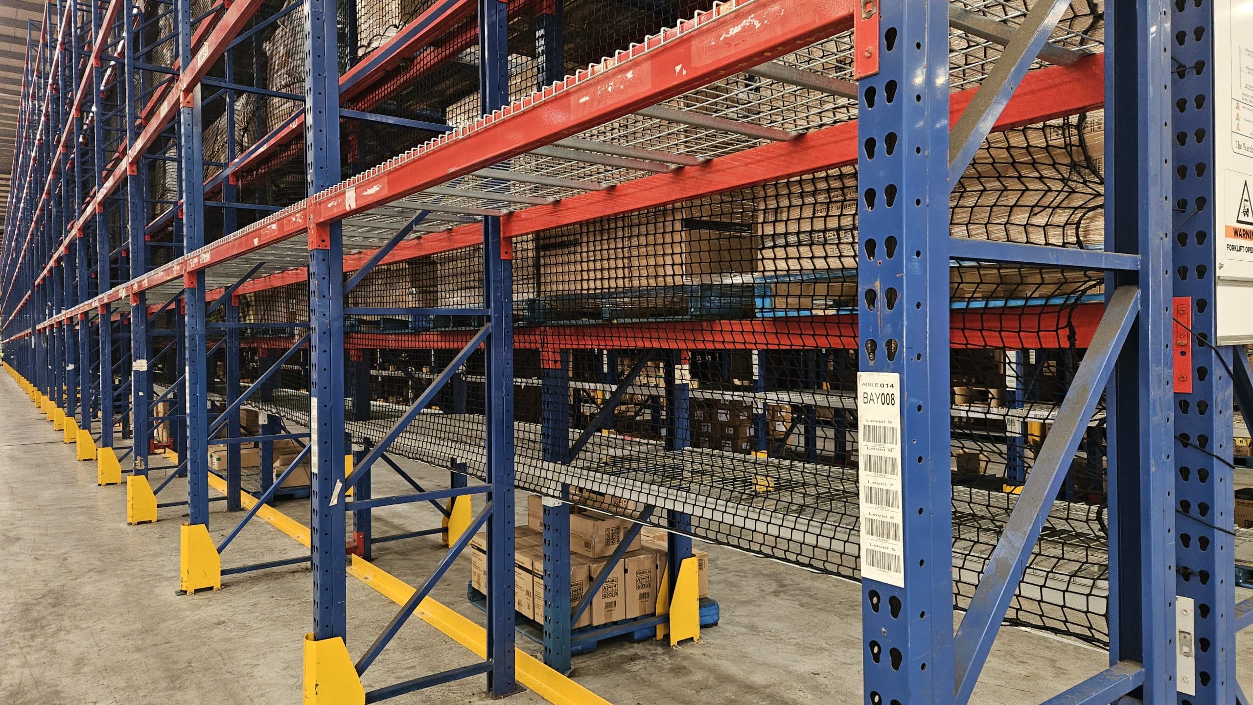 Pallet rack netting installed on warehouse racking